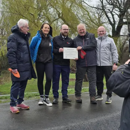 5 members of the Abergele Wheelers CIC holding a plaque.